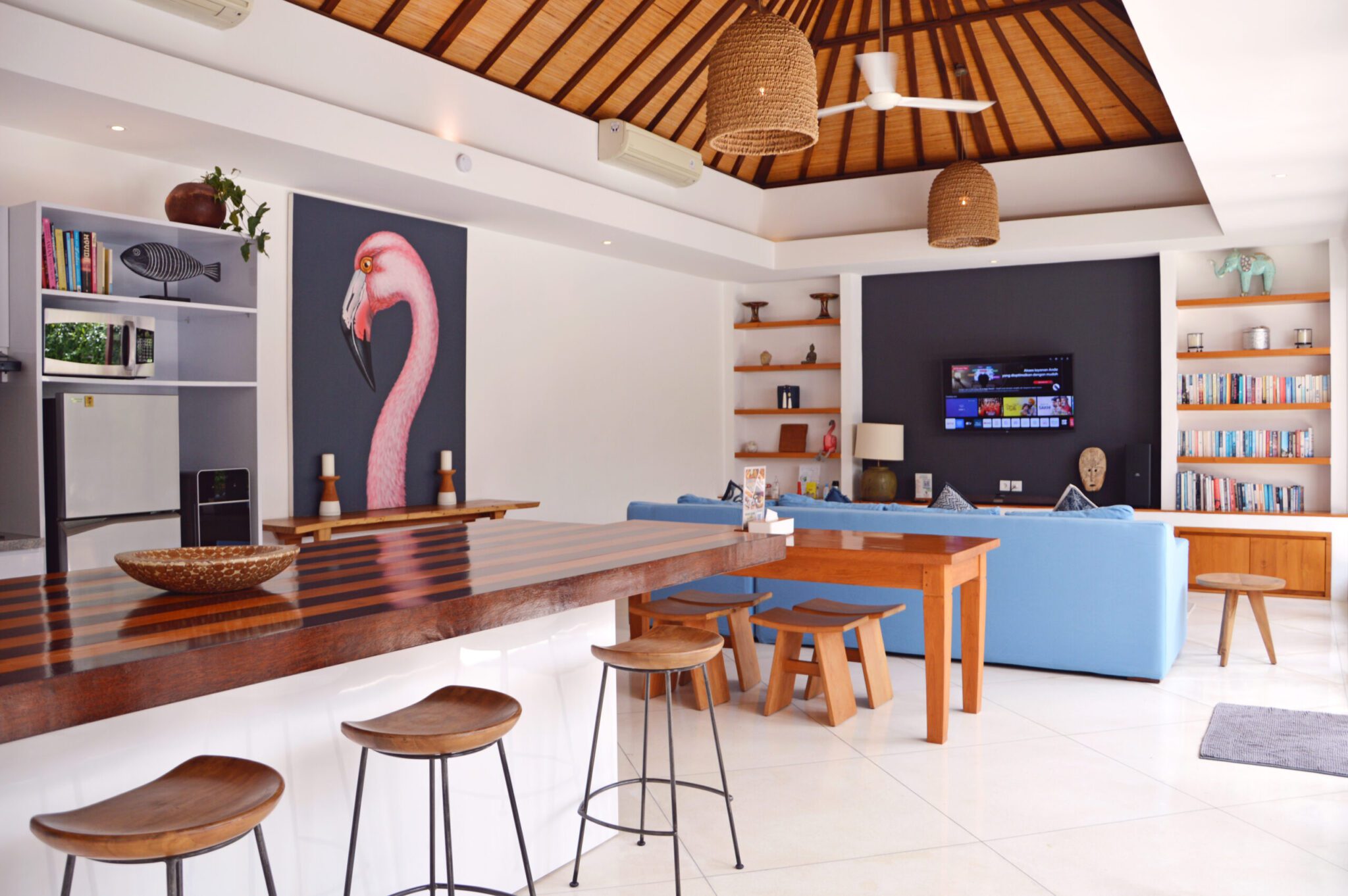 Tropical indoor-outdoor living and dining concept showing the breezy lounge space at Villa Umah Kupu-Kupu 2 Seminyak by Villa Bugis villa Seminyak.