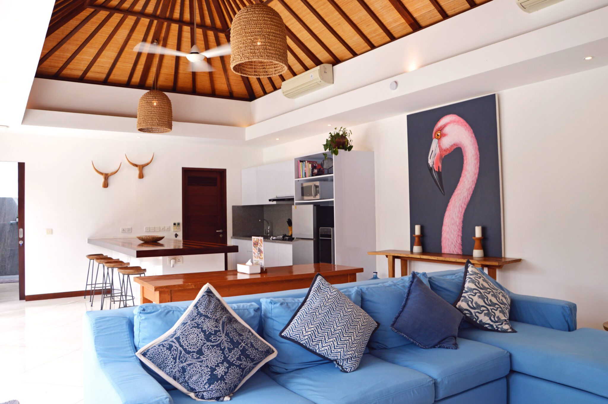 Open-air living room pavilion with plush sofa seating facing the private pool at Villa Umah Kupu-Kupu 2 Seminyak by Villa Bugis villa Seminyak.