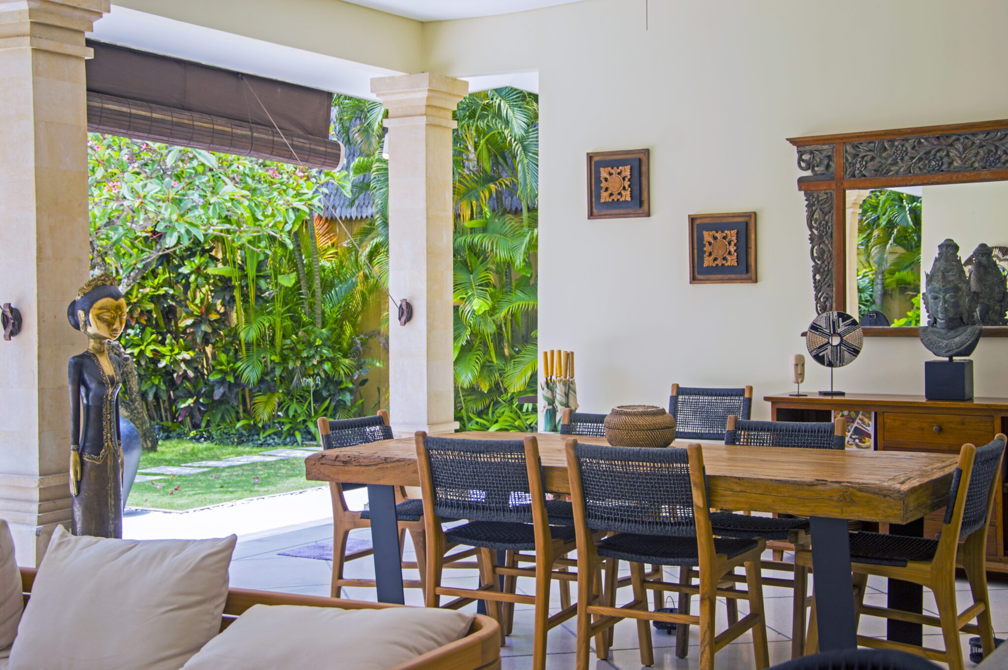 Spacious dining and counter space in the open-air kitchen area overlooking the garden at Villa Vara Seminyak by Villa Bugis Seminyak villas.