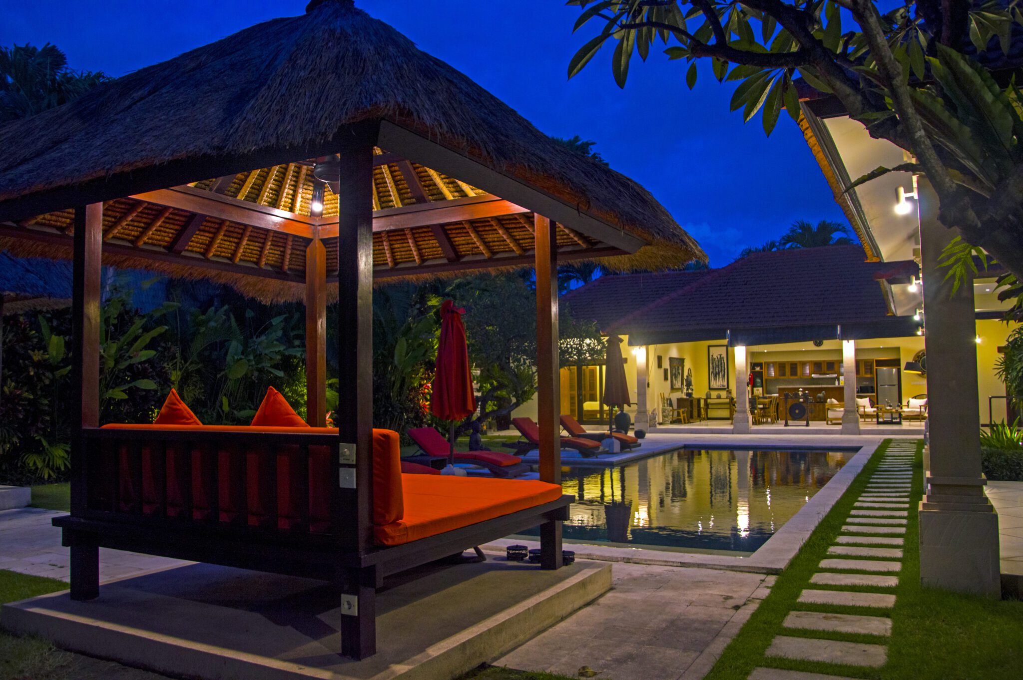 Peaceful nightscape showing the lit swimming pool area at Villa Vara Seminyak by Villa Bugis Seminyak villas.