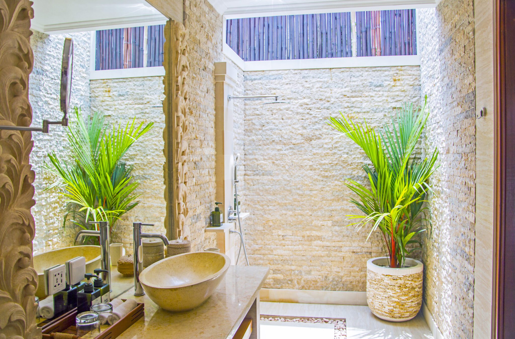 Tropical semi-outdoor ensuite bathroom attached to bedroom 1 at Villa Vara Seminyak by Villa Bugis, offering a unique villa Seminyak experience.