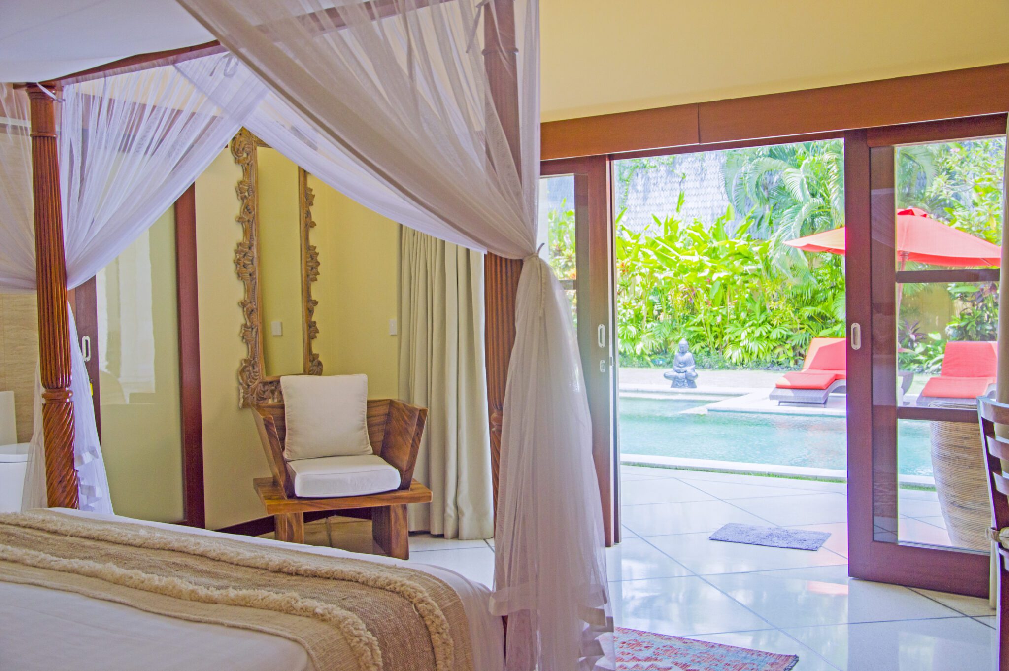 Tastefully decorated interior of bedroom 2 with pool views at Villa Vara Seminyak by Villa Bugis villa Seminyak, featuring soft natural daylighting.